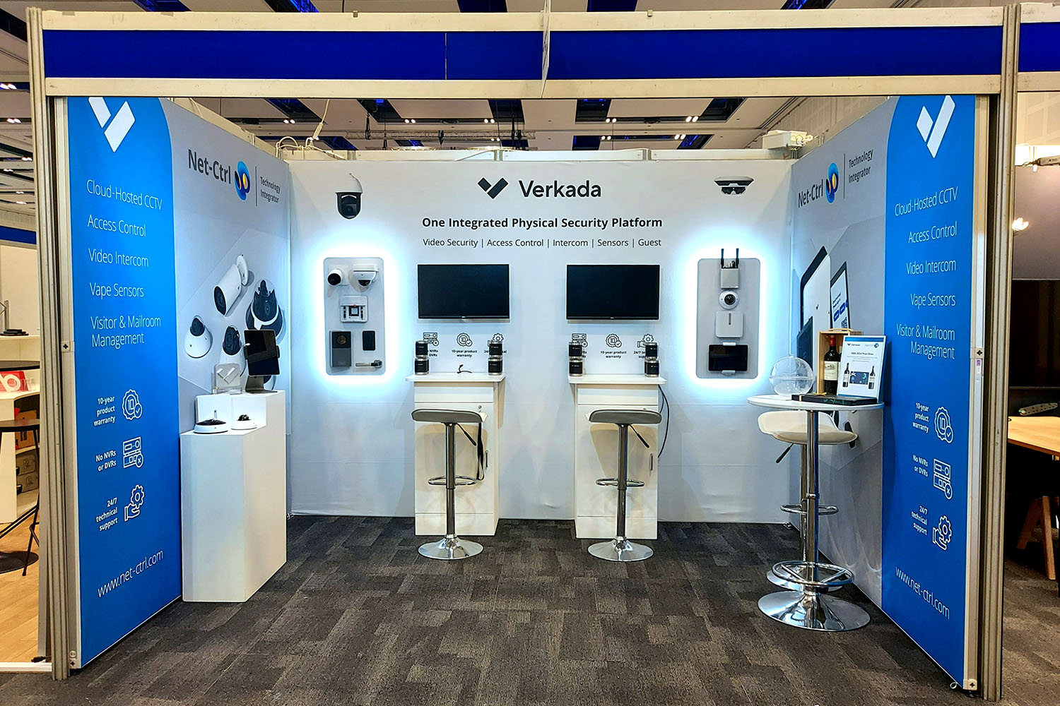 Photo of a customised shell scheme with seamless graphics and wall mounted screens.